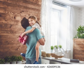 Happy Loving Family And Father's Day. Father And His Daughter. Cute Child Girl Gives A Gift To Dad.