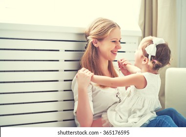 Happy loving family. mother and child girl playing, kissing and hugging