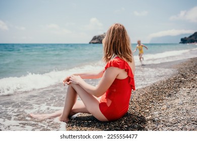 Happy loving family mother and daughter having fun together on the beach. Mum playing with her kid in holiday vacation next to the ocean - Family lifestyle and love concept - Shutterstock ID 2255554477