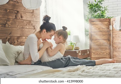 Happy loving family. Mother and her daughter child girl playing and hugging. - Powered by Shutterstock