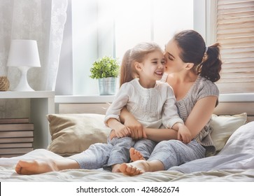 Happy loving family. Mother and her daughter child girl playing and hugging. - Shutterstock ID 424862674