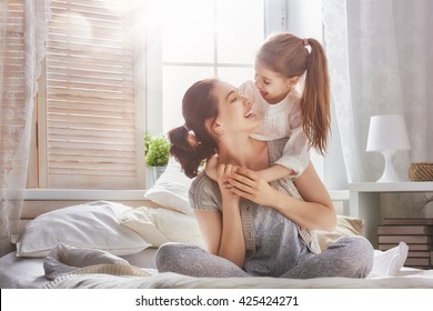 Happy loving family. Mother and her daughter child girl playing and hugging. - Shutterstock ID 425424271