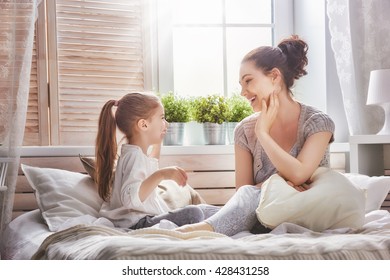Happy loving family. Mother and her daughter child girl playing in bed. - Shutterstock ID 428431258