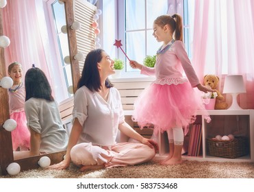 Happy Loving Family. Mother And Her Daughter In Kids Room. Funny Mom And Lovely Child Having Fun Indoors. Cute Little Girl Is Playing Princess Fairy.