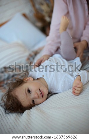 Similar – Little girl smiling lying over the bed