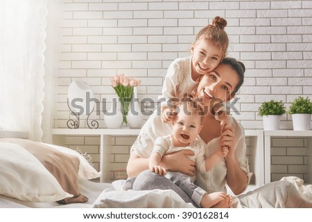 Similar – Image, Stock Photo Young mother with her cute infant baby boy child sitting on bench in city park