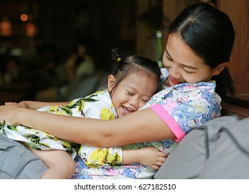Happy loving family. mother hugging her child on sofa.