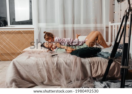 Young adult couple kissing each other on couch