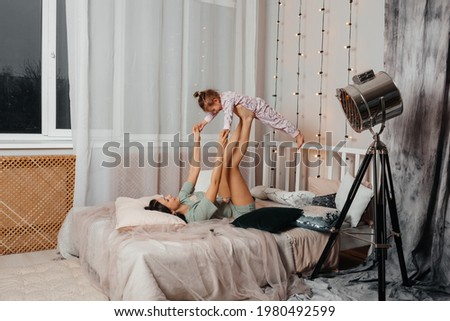 Similar – Young adult couple kissing each other on couch