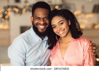 Happy Loving Family. Portrait of beautiful young african american couple in love posing and looking at camera. Smiling black bearded man embracing and hugging his pretty woman. Healthy Relationship - Powered by Shutterstock