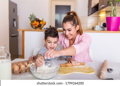 Happy Loving Family Are Preparing Bakery Together. Mother And Child Son Boy Are Cooking Cookies And Having Fun In The Kitchen. Homemade Food And Little Helper.