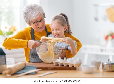 Happy loving family are preparing bakery together. Granny and child are cooking cookies and having fun in the kitchen.  - Powered by Shutterstock