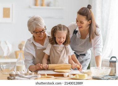 Happy loving family are preparing bakery together. Granny, mom and child are cooking cookies and having fun in the kitchen. Homemade food and little helper. - Powered by Shutterstock