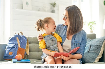 happy loving family. pretty young mother and her daughter are writing in notebook.                                - Shutterstock ID 1470485516