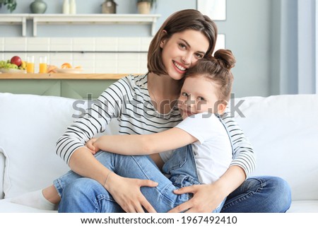 Happy loving mom hugging little daughter, spend time together at home