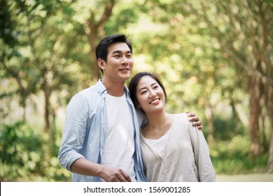 Happy Loving Young Asian Couple Relaxing In Park