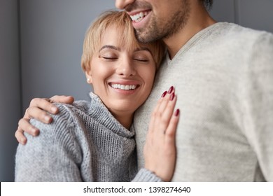 Happy Loyal Woman With Closed Eyes Leaning On Chest Of Reliable Man While Spending Time At Home