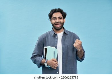 Happy Lucky Arab Young Man Student Winner Standing Isolated On Blue Background Celebrating University Admission, Win International Grant Or Scholarship Programs. Having Good Exam Results.