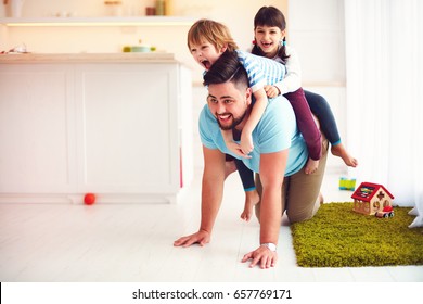 happy mad ride on father's back. when you home alone with kids - Shutterstock ID 657769171