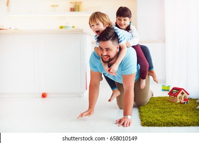 happy mad ride on father's back. when you home alone with kids - Shutterstock ID 658010149