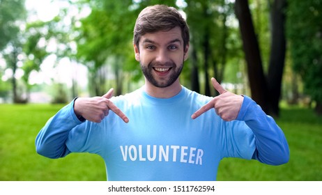 Happy Male Activist Pointing At Volunteer Word On Blue T-shirt, Eco Project