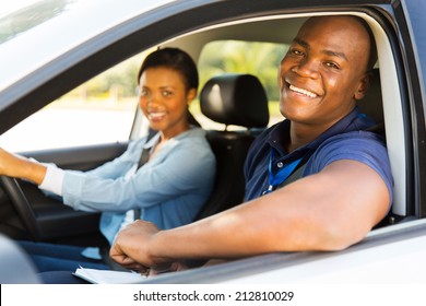 Happy Male African American Driving Instructor And Student Driver During Lesson