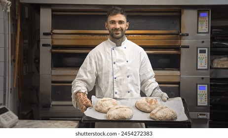 Happy male baker take bread out of hot oven. Smiling man cook tasty fresh loaf. Cafe staff bake warm eat bun. Bakery guy look camera. 40s head chef portrait. Person making meal job. Pastry food house. - Powered by Shutterstock