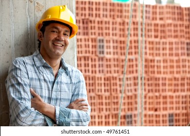 Happy Male Construction Worker Wearing A Helmet And Smiling