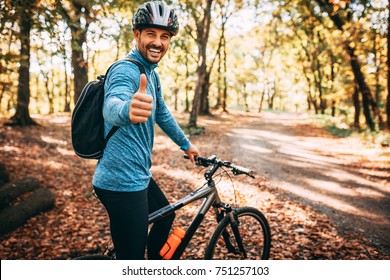 Happy Male Cyclist In Forest.