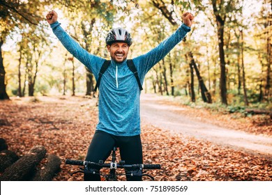 Happy Male Cyclist In Forest. Excited. Victory.