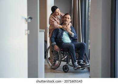 Happy male with disability spending day with wife indoors - Powered by Shutterstock