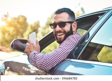 Happy Male Driver Smiling While Sitting In A Car With Open Front Window