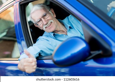 Happy Male Driver With Thumbs Up In A Car