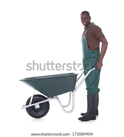 Happy Male Gardener Holding Wheelbarrow Over White Background