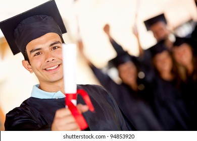 Happy Male Graduate Holding His Diploma And Smiling