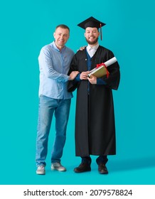 Happy Male Graduation Student With His Father On Color Background