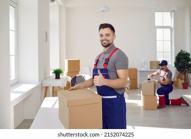 Happy male mover worker with cardboard box show thumbs up recommend good quality delivery company service. Smiling deliveryman with package give recommendation to moving or relocation help. - Powered by Shutterstock