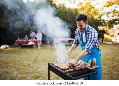 Happy male preparing bbq meat