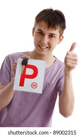 A Happy Male Teen Holds A Red P Plate And Car Key With Thumbs Up Success Sign.  White Background.