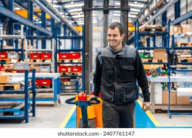 Happy male worker carrying a chart in a corridor of a logistic factory - Powered by Shutterstock