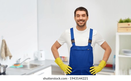 Happy Male Worker Or Cleaner In Gloves At Kitchen