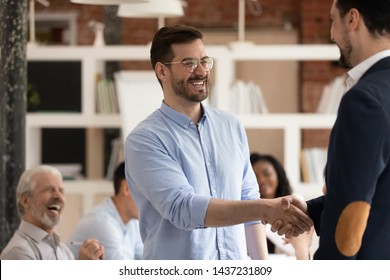 Happy Male Worker Feel Excited Get Promoted Rewarded Being Best Employee Handshake Manager Praising Apprecitaing Thanking For Good Work In Office, Staff Reward, Trust, Recognition And Respect Concept