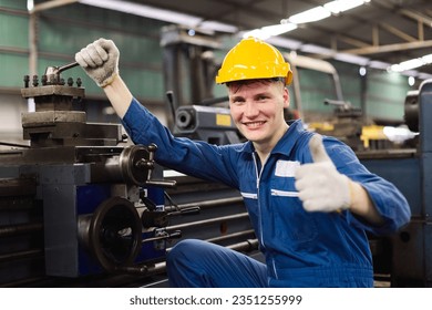 Happy male workers wear yellow hard hat holding wrench working on repairing factory machinery. man maintenance Factory, mechanical repairman concept. - Powered by Shutterstock