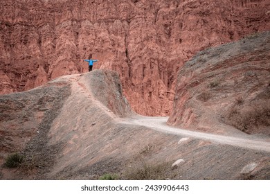 Happy man after climbing a mountain in northern Argentina. Mountaineer climbing mountain in Purmamarca, Jujuy, Argentina. Young mountaineer in Purmamarca and its colorful mountains - Powered by Shutterstock