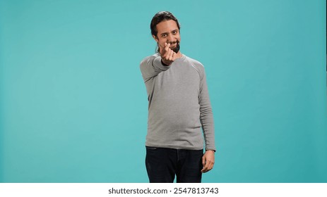 Happy man asking for money with hand gesture, rubbing fingers together in order to receive cash payment. Jolly person requesting financial bribe, doing extorsion, studio background, camera A - Powered by Shutterstock