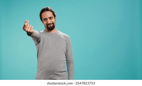 Happy man asking for money with hand gesture, rubbing fingers together in order to receive cash payment. Jolly person requesting financial bribe, doing extorsion, studio background, camera B - Powered by Shutterstock