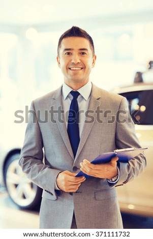 happy man at auto show or car salon