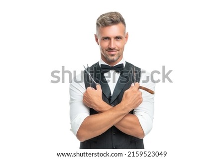happy man barber with razor blade and scissors in bow tie isolated on white background