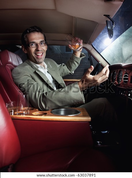Happy man in the car
drinking