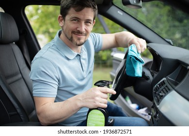 Happy Man Cleans A Car Inside